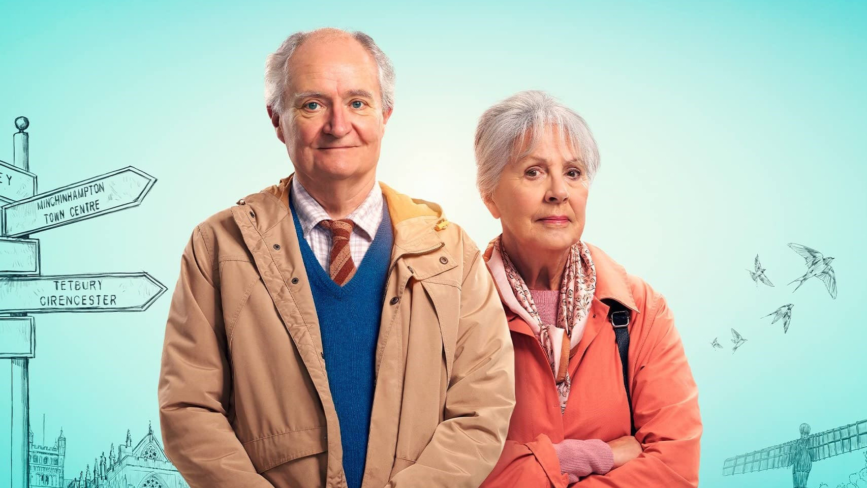 An elderly man and woman looking into the camera, in front of a blue backdrop with drawn signposts