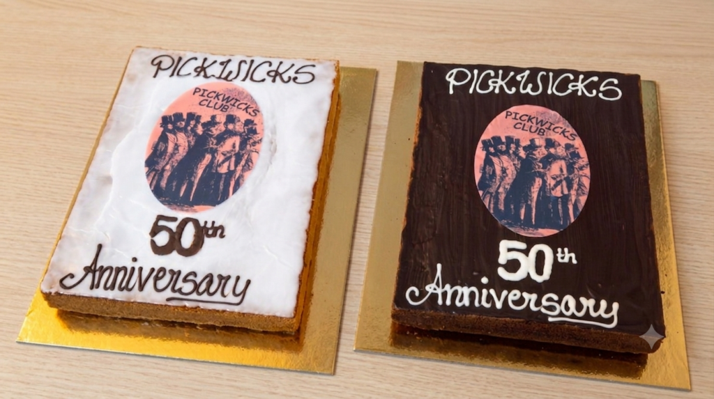Two anniversary cakes, one with light icing and one with dark, each displaying the pink oval Pickwicks Club logo and the words 'Pickwick's 50th Anniversary'